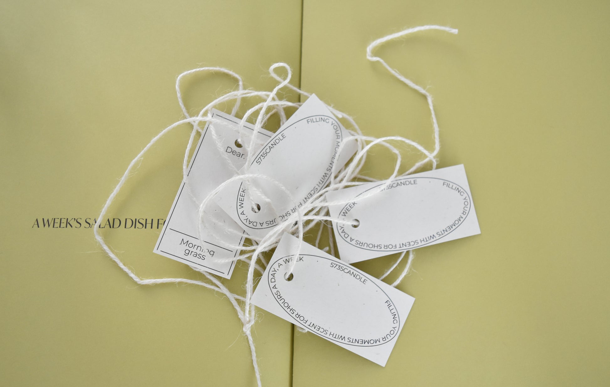 White tags with text on a light green background，Honey Flamingo，韓國設計品牌，天然大豆香氛蠟燭