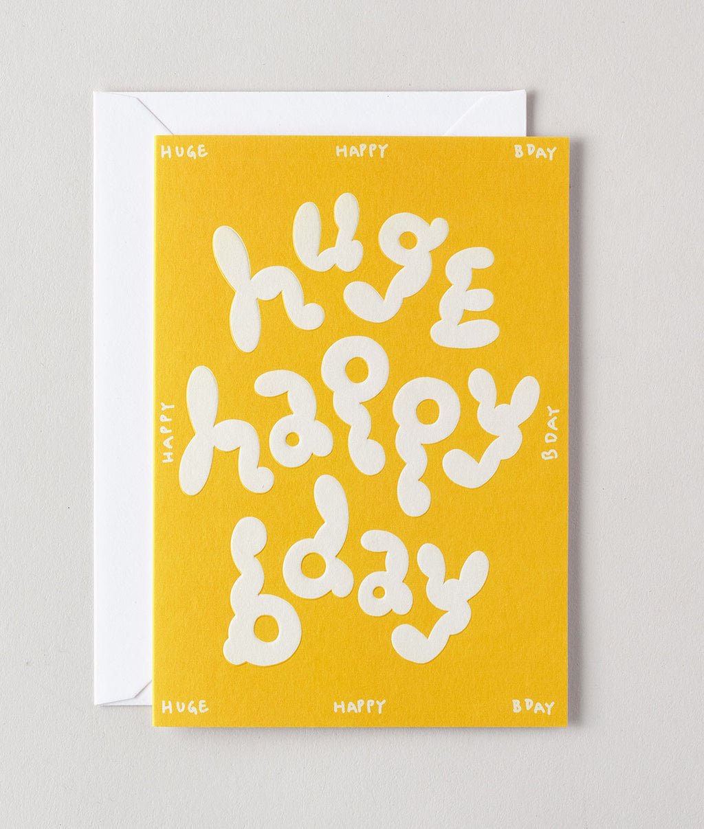 Wrap 英國插畫品牌卡片，黃色底搭配白色氣泡字 huge happy bday，適合生日或慶祝使用